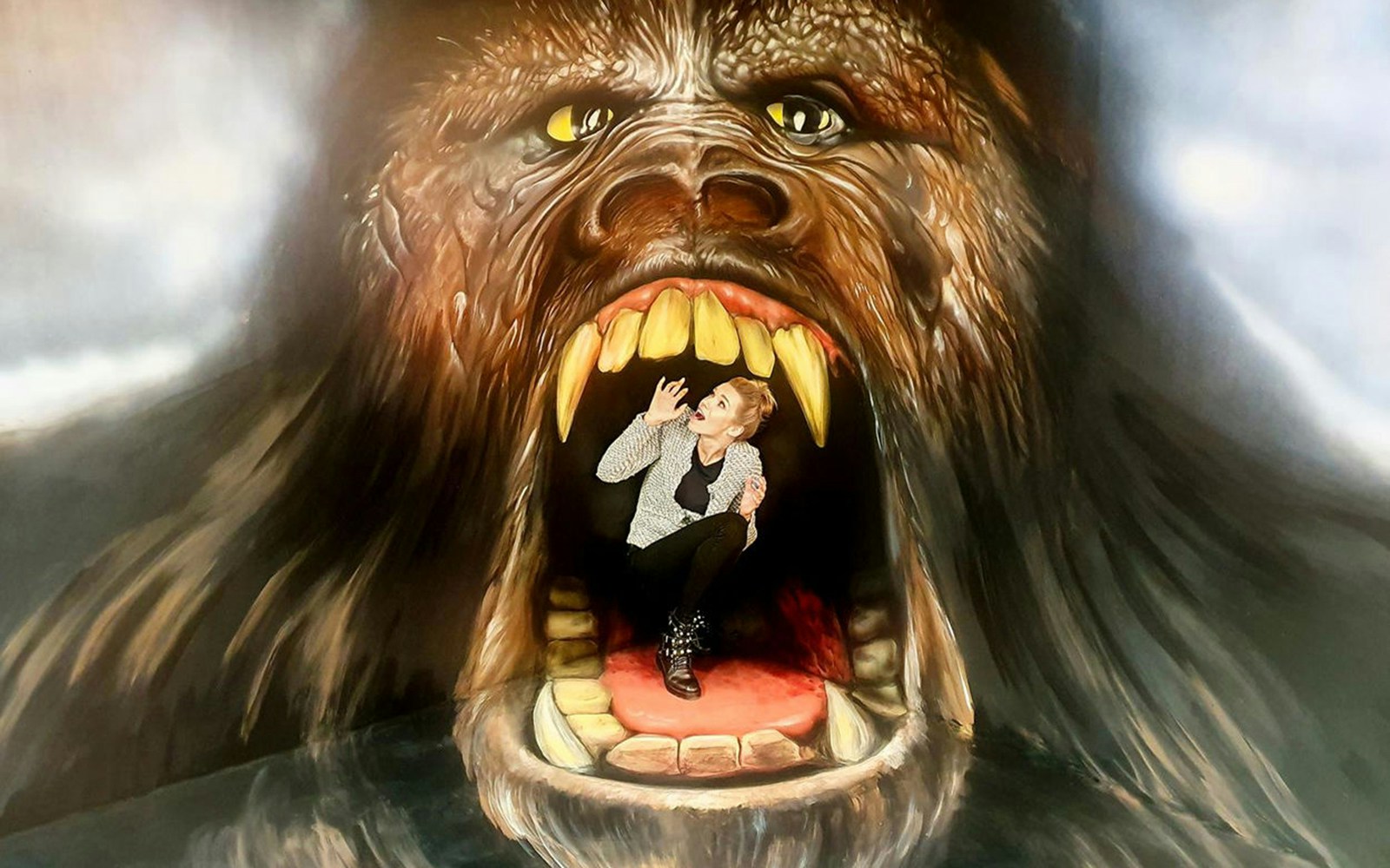Person posing inside King Kong's mouth at Museum of Fantastic Illusions.