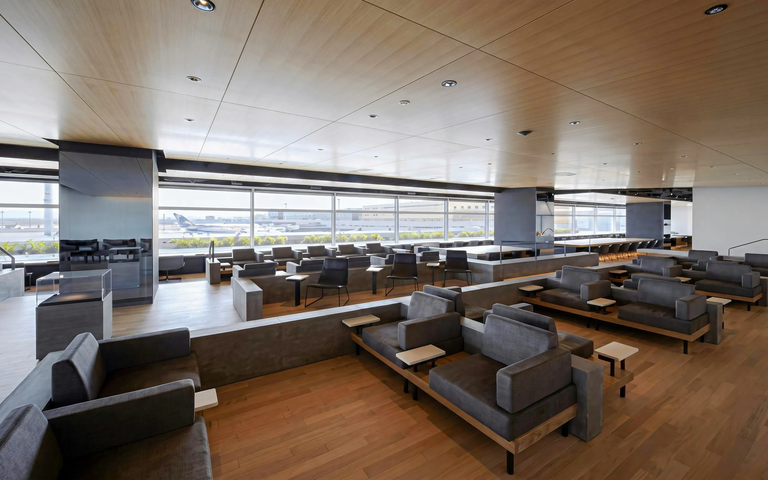 Power Lounge North seating area at Tokyo International Airport Terminal 2 with runway view.