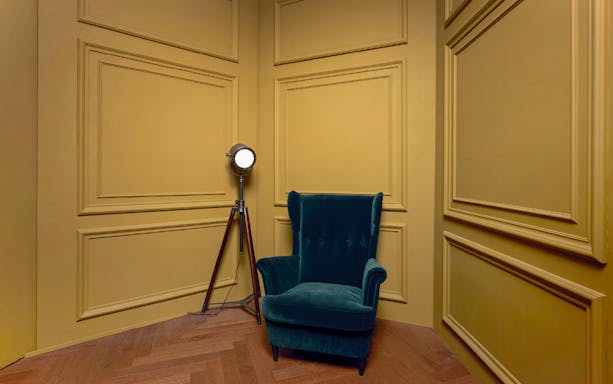 Studio Seeik Seoul photo shoot setup with green armchair and spotlight.