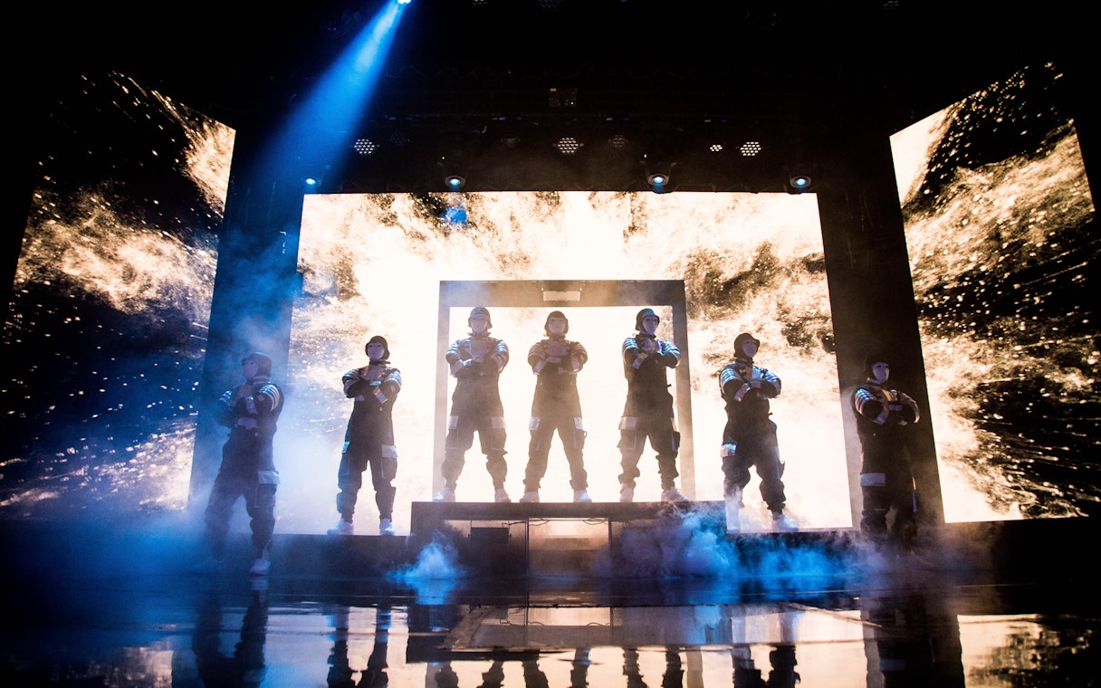 Jabbawockeez dancers performing on stage with dynamic lighting in Las Vegas show.