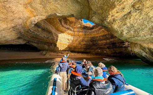 Tourists on a speedboat entering Benagil Cave, Algarve, Portugal.