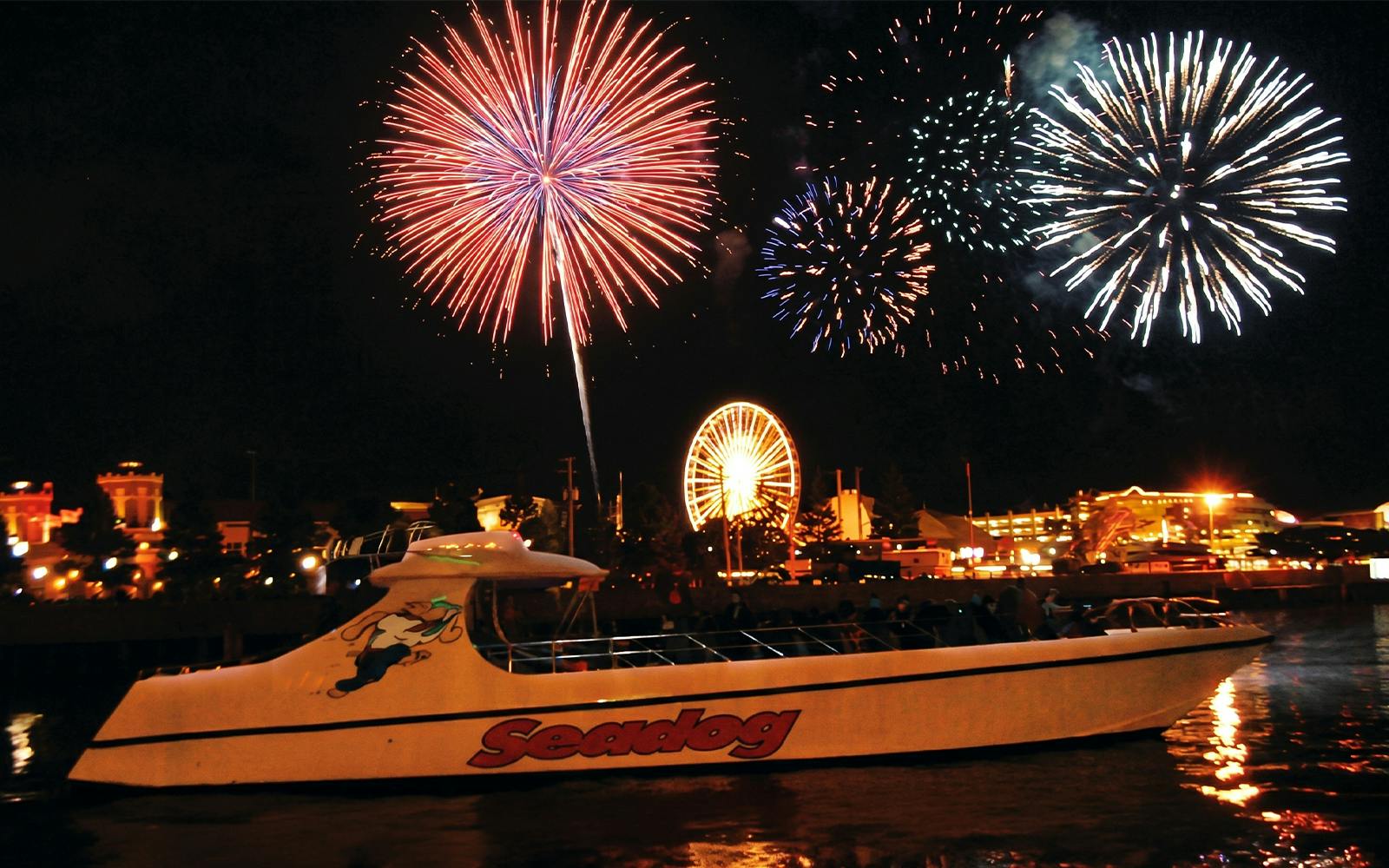 Fireworks over Lake Michigan with Sea Dog boat and Chicago skyline.