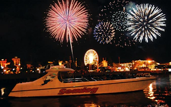 Fireworks over Lake Michigan with Sea Dog boat and Chicago skyline.