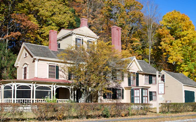 Wayside House in Boston surrounded by autumn trees.