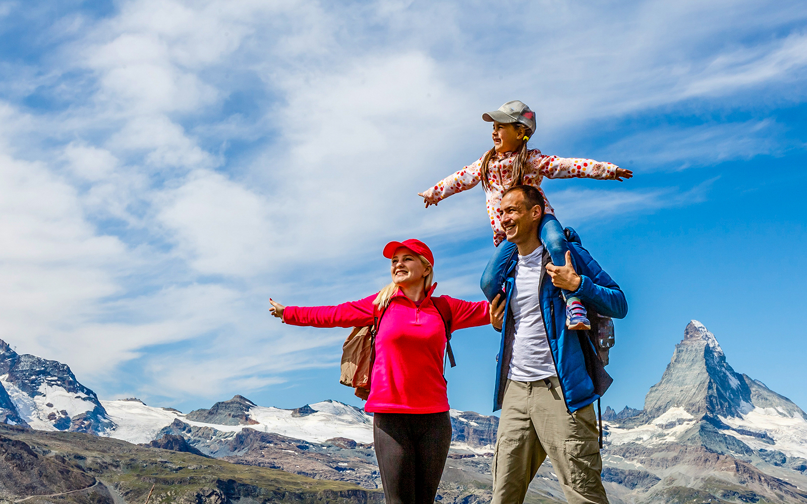Family hiking on Mount Titlis with scenic mountain views.