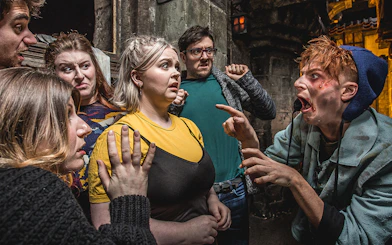 Group reacting to actor portraying the Foul Clenger at Mary Kings Close, Edinburgh Dungeon.