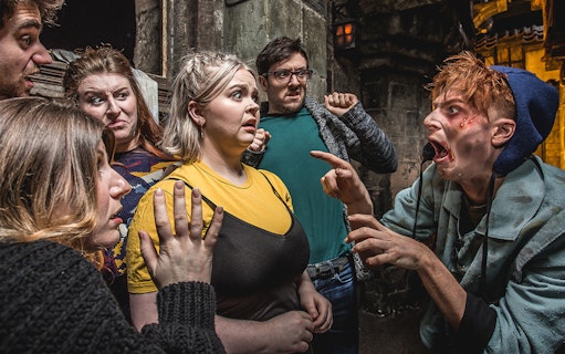 Group reacting to actor portraying the Foul Clenger at Mary Kings Close, Edinburgh Dungeon.