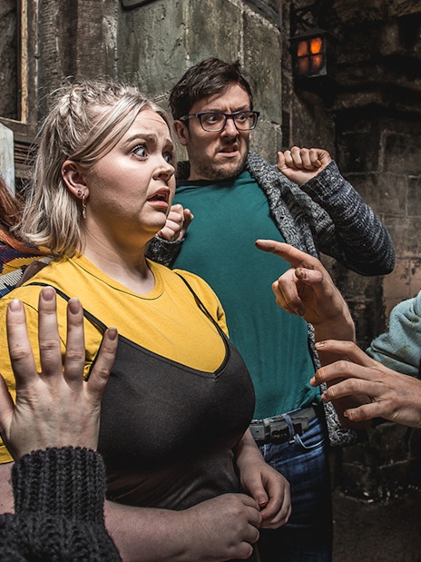 Group reacting to actor portraying the Foul Clenger at Mary Kings Close, Edinburgh Dungeon.