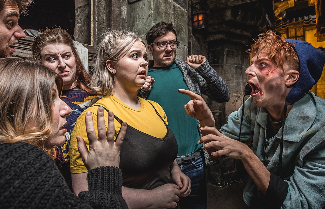 Group reacting to actor portraying the Foul Clenger at Mary Kings Close, Edinburgh Dungeon.