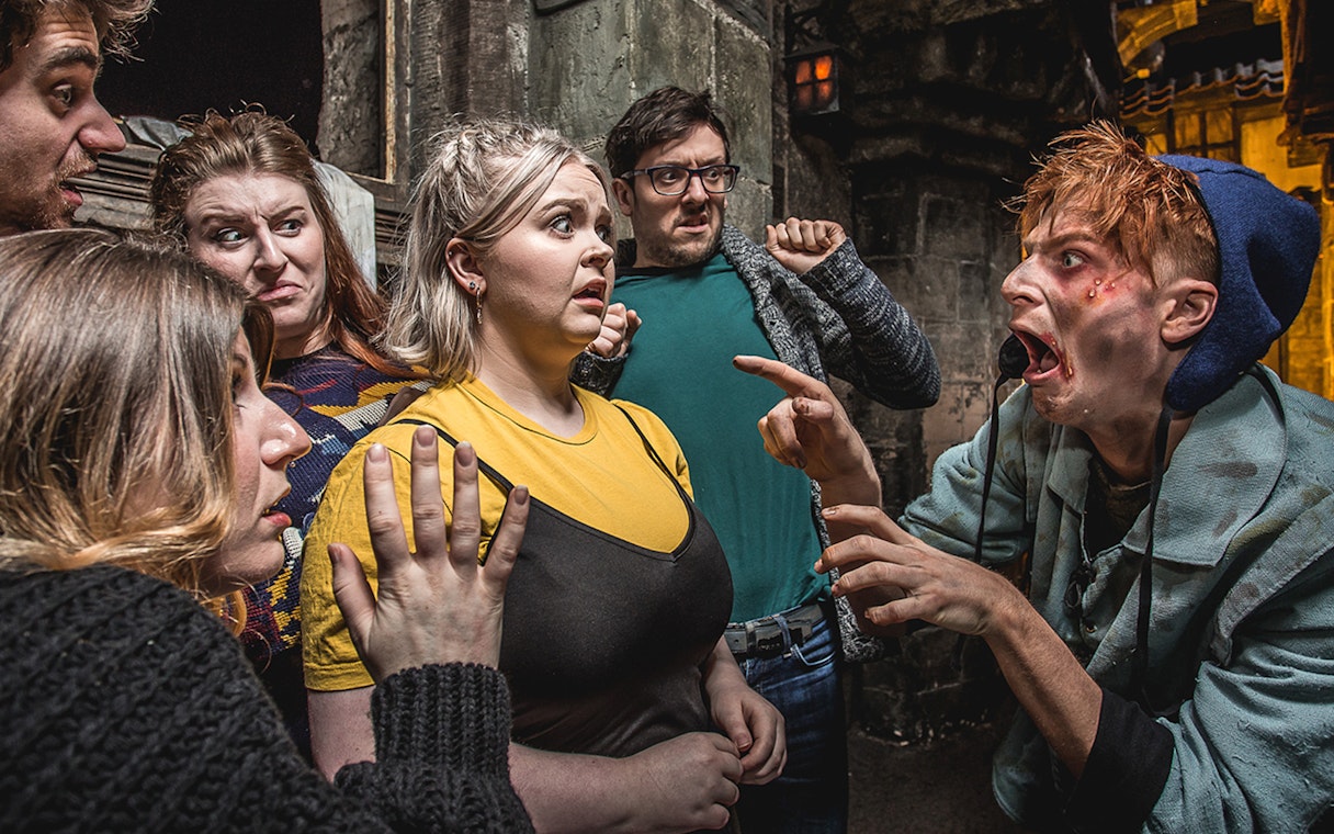 Group reacting to actor portraying the Foul Clenger at Mary Kings Close, Edinburgh Dungeon.