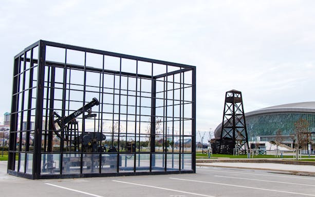Oil well display and modern architecture in Baku, Azerbaijan.