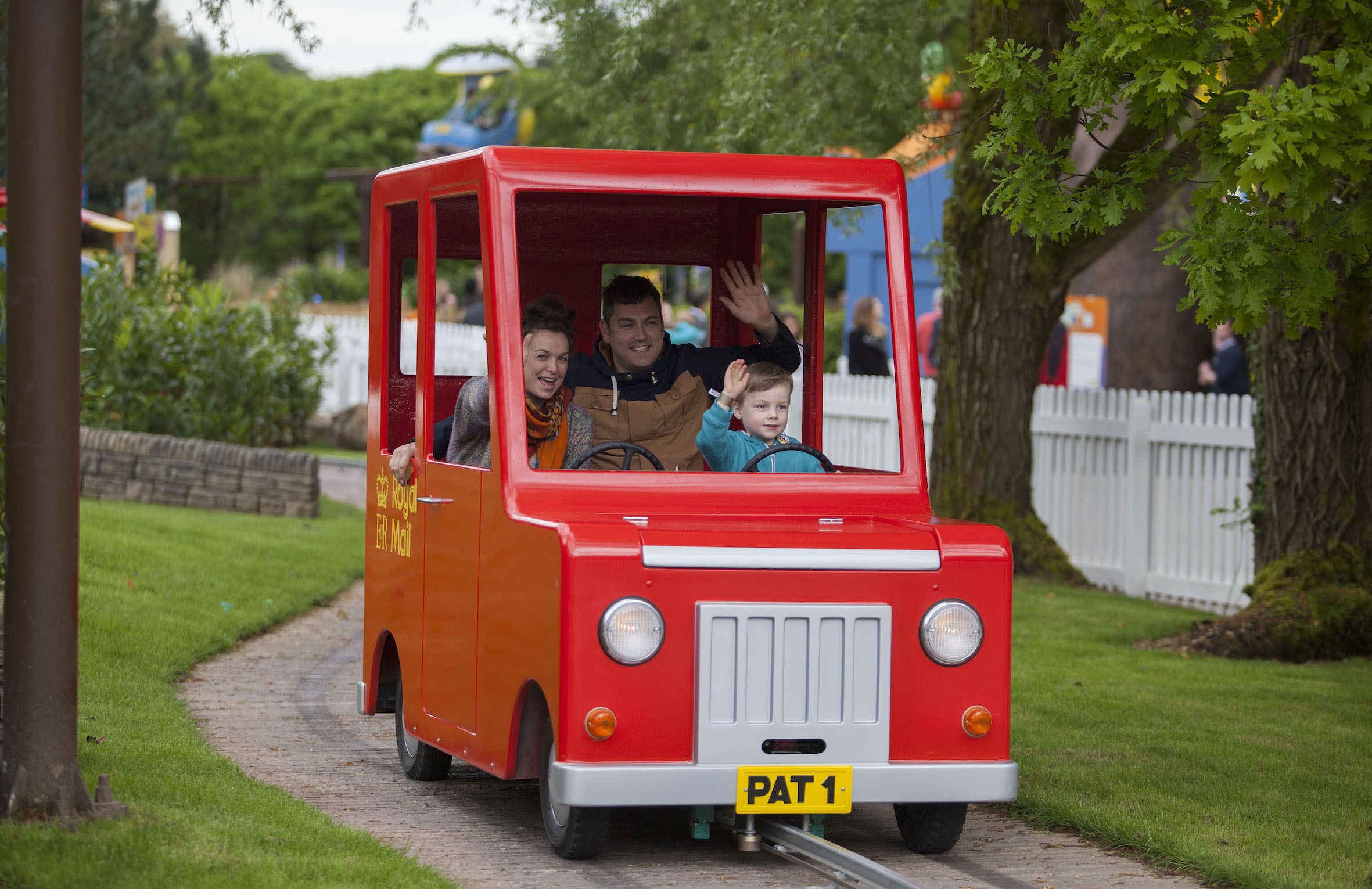 Postman Pat ride at CBeebies Land, Alton Towers, featuring colorful vehicles and scenic backdrop.