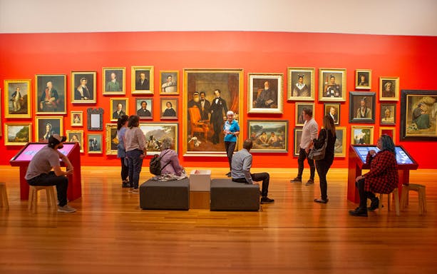 Visitors viewing portrait gallery at Te Papa Tongarewa Museum's Gallipoli Exhibition.