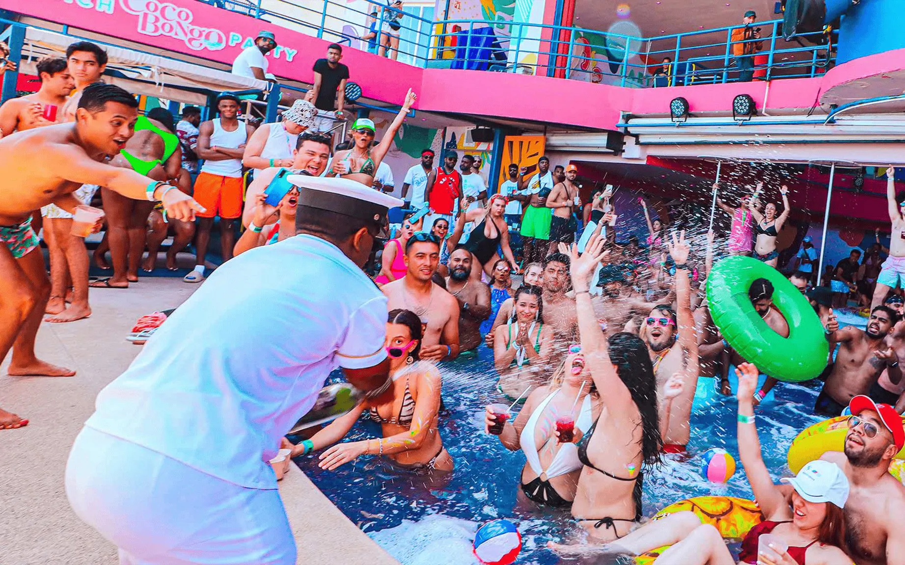 Partygoers enjoying the pool at Coco Bongo Beach Party with lively atmosphere.