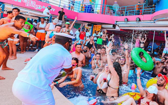 Partygoers enjoying the pool at Coco Bongo Beach Party with lively atmosphere.