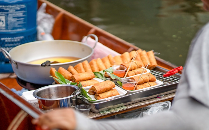 Spring rolls on a boat at Damnoen Saduak Floating Market, Thailand.