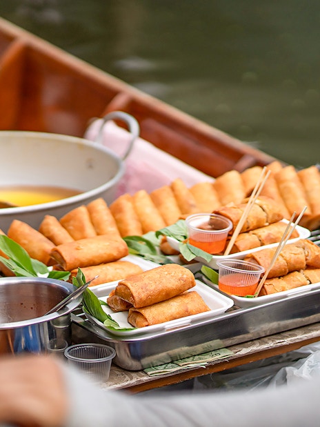 Spring rolls on a boat at Damnoen Saduak Floating Market, Thailand.
