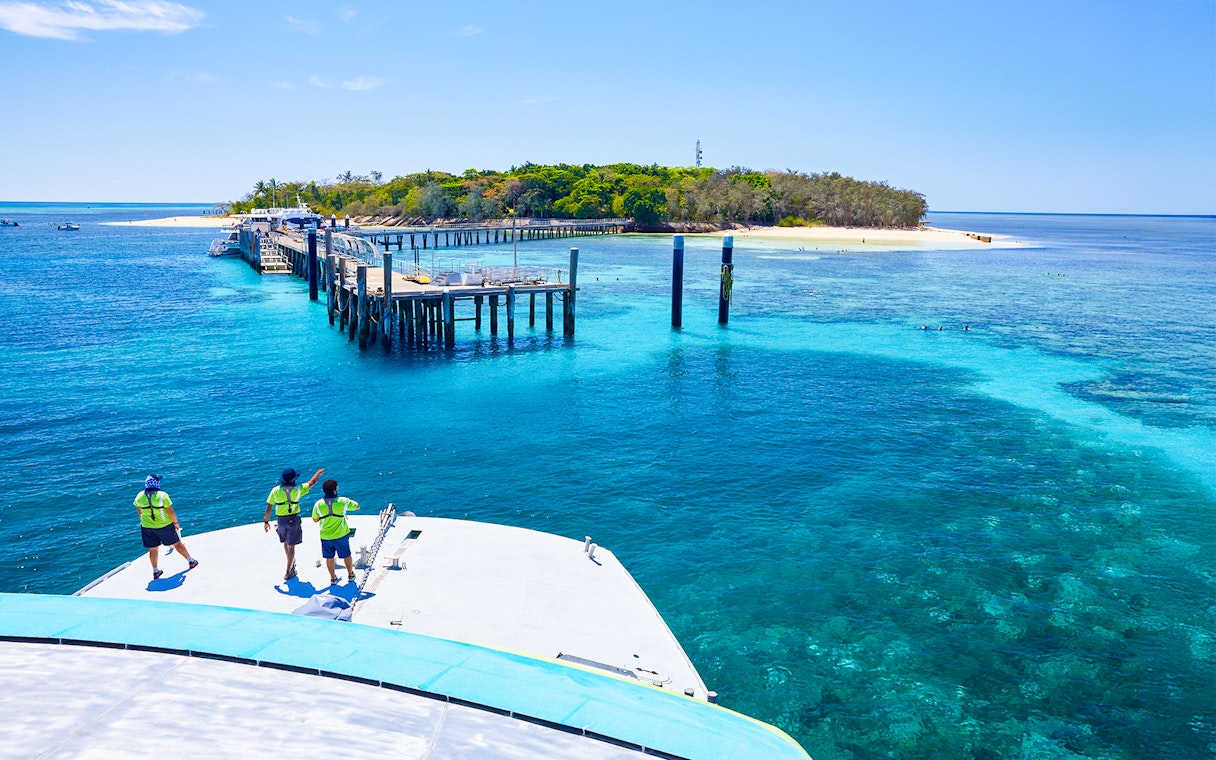 Catamaran approaching Green Island pier on Full Day Reef Cruise, Australia.
