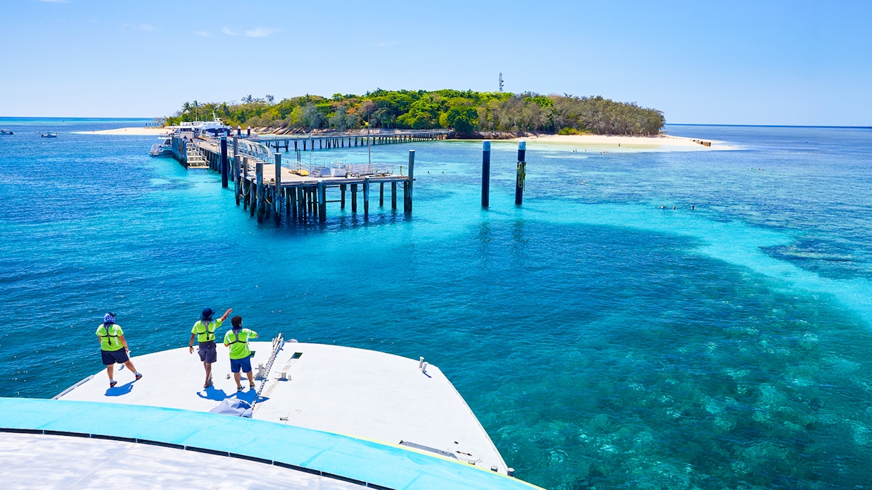 Catamaran approaching Green Island pier on Full Day Reef Cruise, Australia.