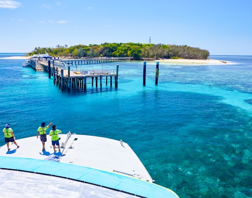 Catamaran approaching Green Island pier on Full Day Reef Cruise, Australia.