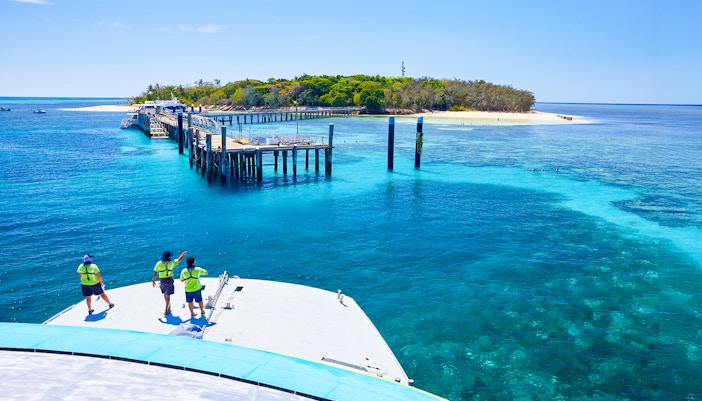 Catamaran approaching Green Island pier on Full Day Reef Cruise, Australia.