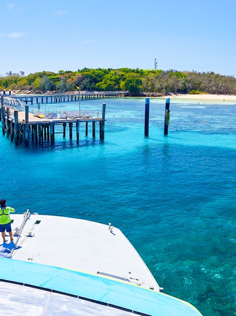 Catamaran approaching Green Island pier on Full Day Reef Cruise, Australia.