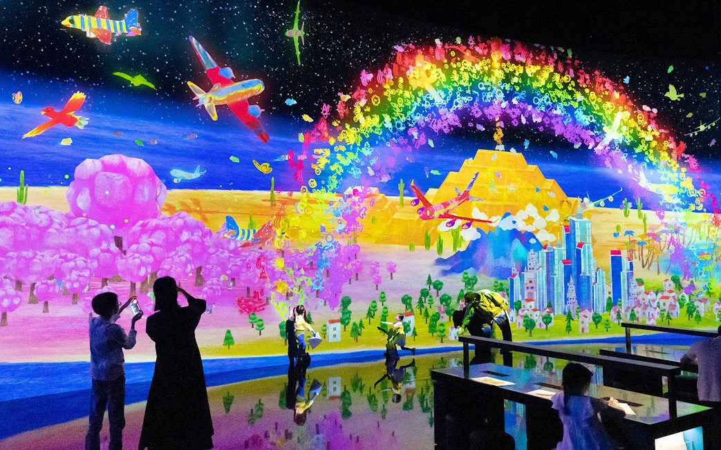 Teamlab digital art installation with vibrant colors at ArtScience Museum, Singapore.