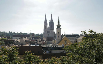Zagreb Cathedral and cityscape view from a scenic spot during a self-guided exploration game.
