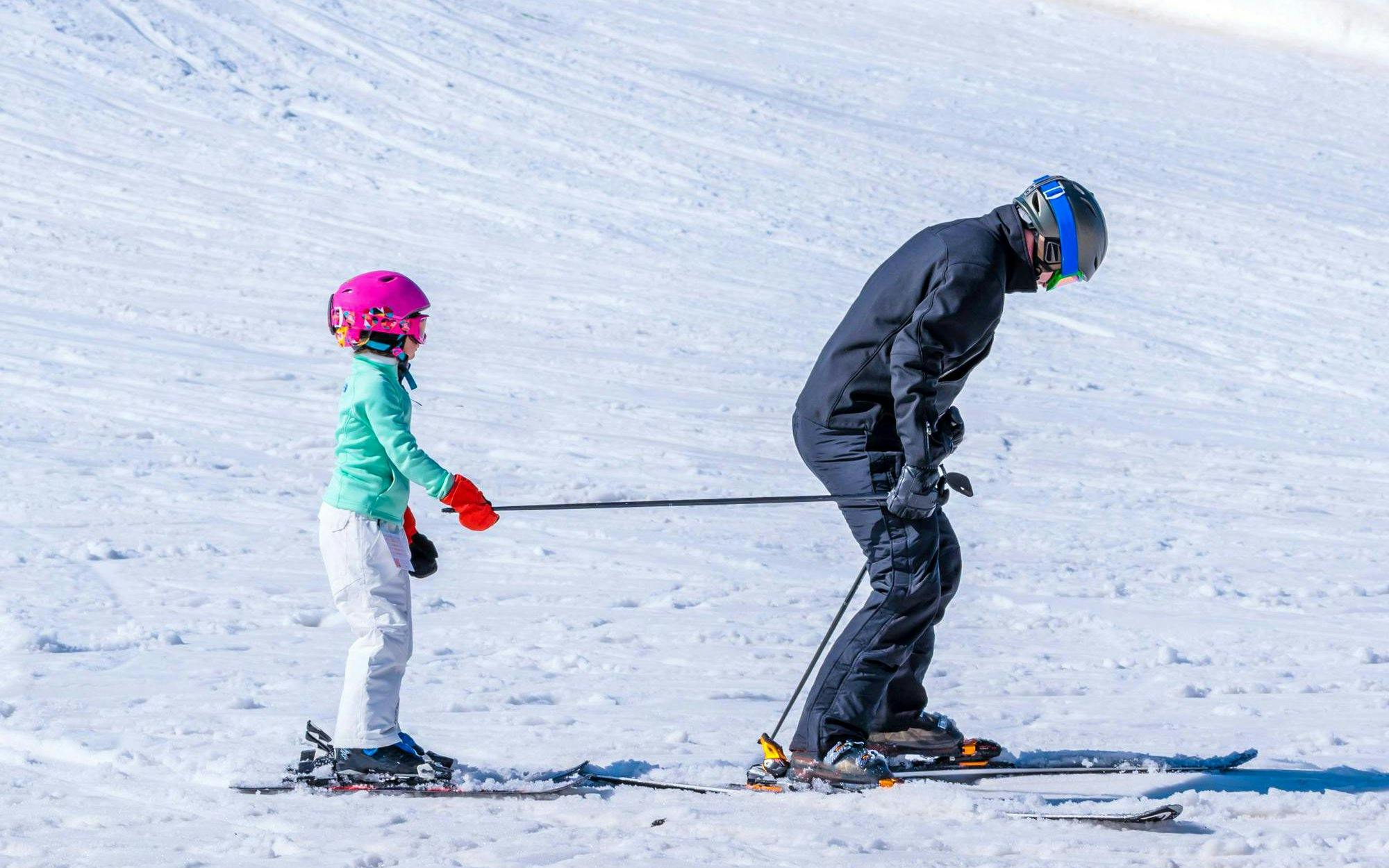Child skiing with harness at Valle Nevado Ski Resort, Chile.