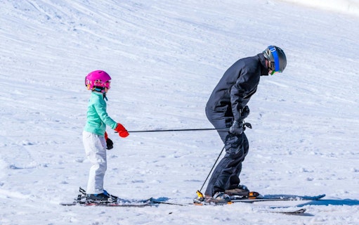 Child skiing with harness at Valle Nevado Ski Resort, Chile.