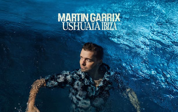 Person in water with 'Martin Garrix Ushuaïa Ibiza' text above, promoting Ibiza event.