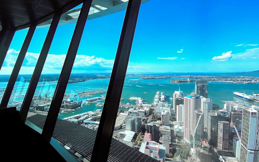 Auckland City skyline and harbor view from Sky Tower observation deck.