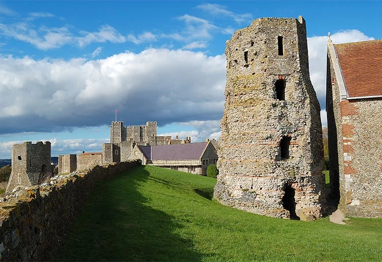 Dover Castle with Roman lighthouse and surrounding buildings in England.