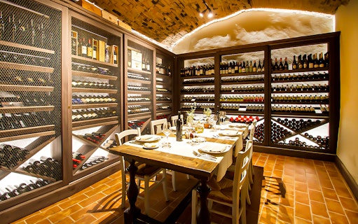 Wine cellar dining setup for wine making experience and gourmet dinner in Tuscany.