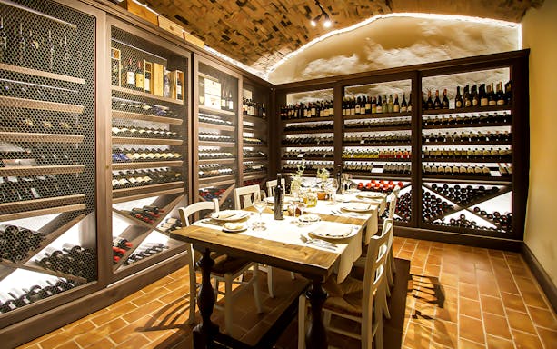 Wine cellar dining setup for wine making experience and gourmet dinner in Tuscany.