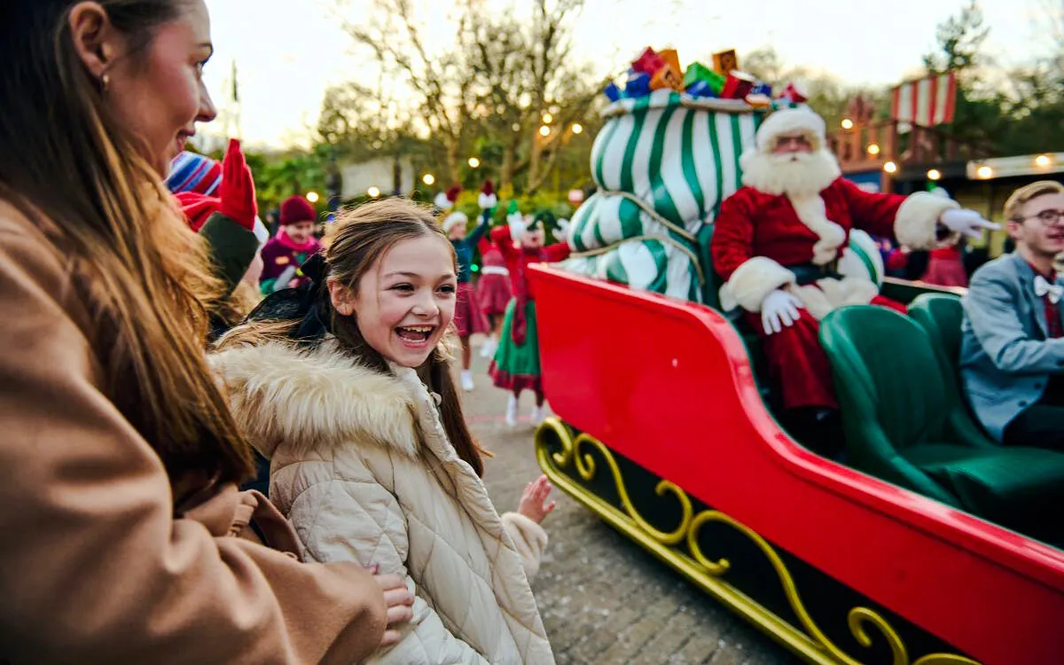 Child enjoying Christmas parade with Santa at Legoland Windsor.