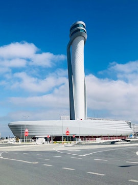 Control tower at Istanbul Airport under a clear blue sky.