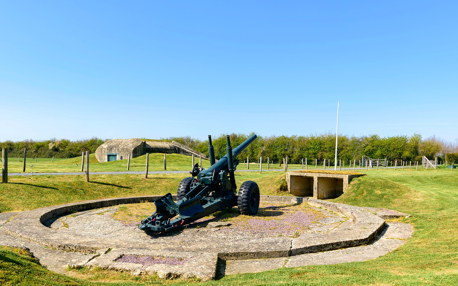 Normandy D-Day site with artillery gun and bunker, France.