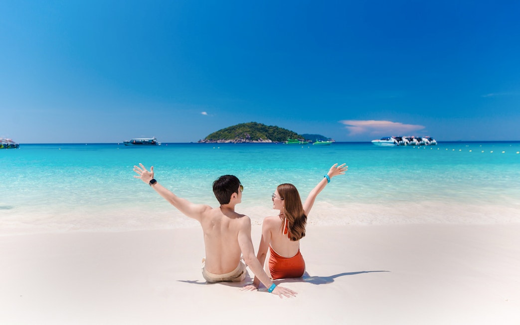 Couple enjoying the beach view on Similan Island, Thailand.