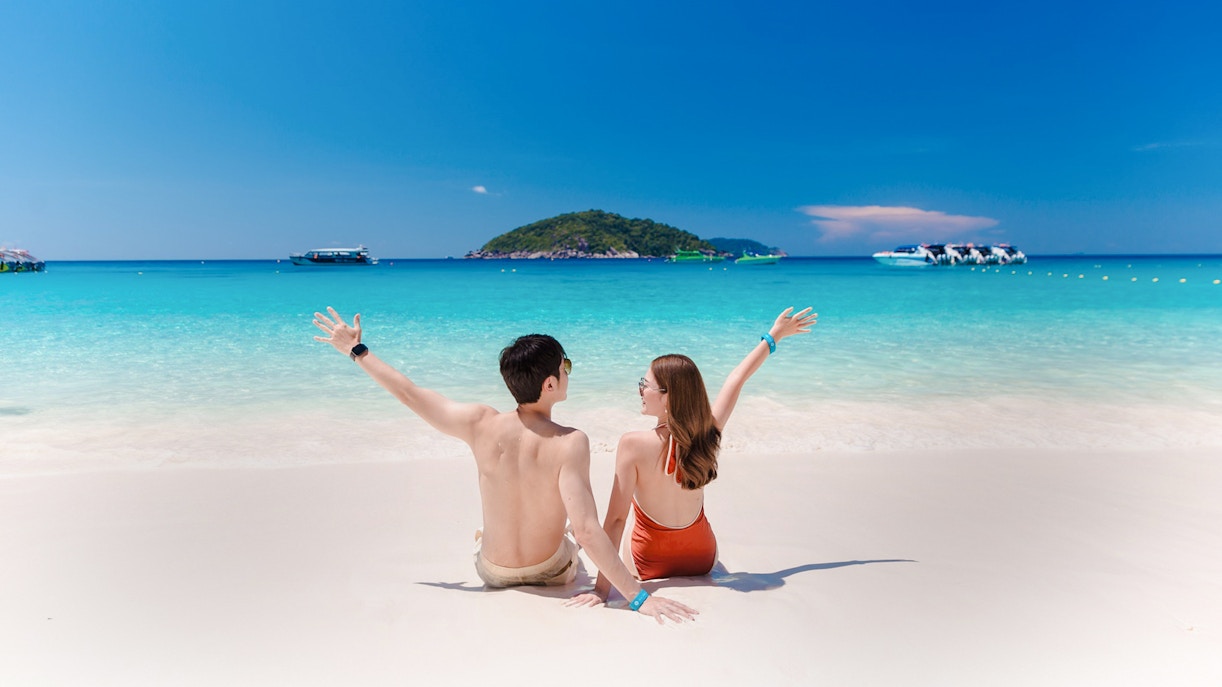 Couple enjoying the beach view on Similan Island, Thailand.