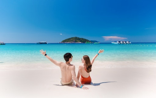 Couple enjoying the beach view on Similan Island, Thailand.