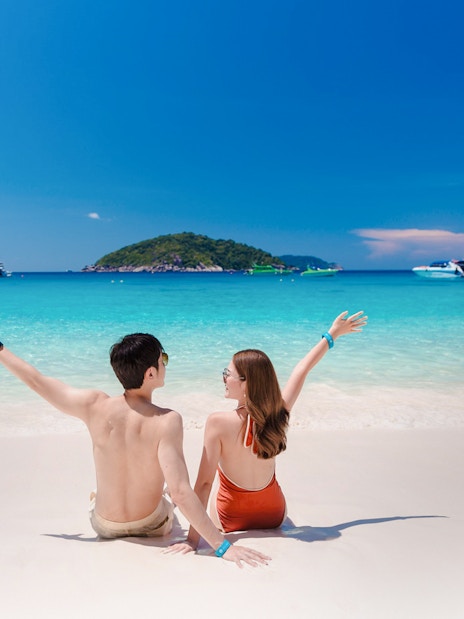 Couple enjoying the beach view on Similan Island, Thailand.