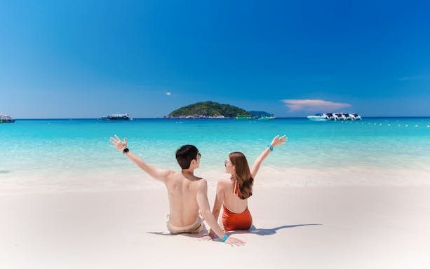 Couple enjoying the beach view on Similan Island, Thailand.