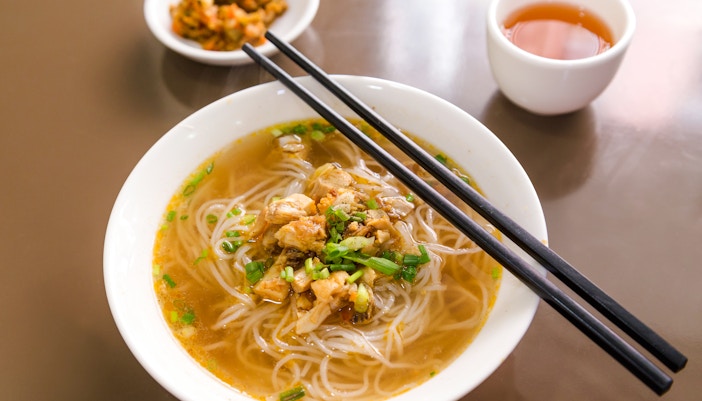 Burmese Shan noodle soup with chopsticks on a table in Myanmar.