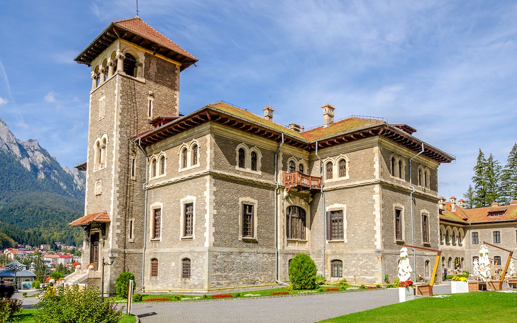 Cantacuzino Castle in Busteni Mountains with scenic backdrop.