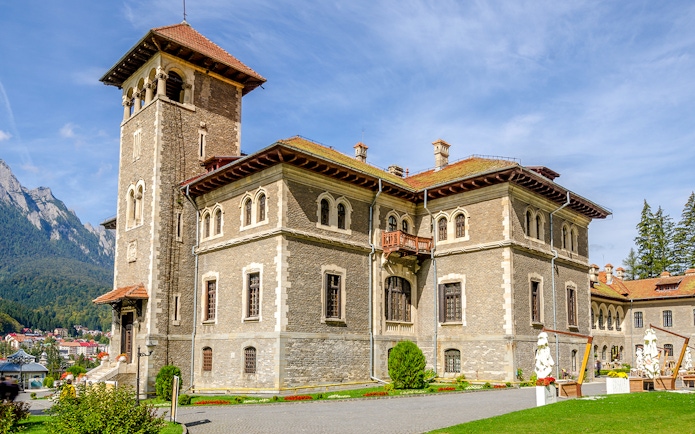 Cantacuzino Castle in Busteni Mountains with scenic backdrop.