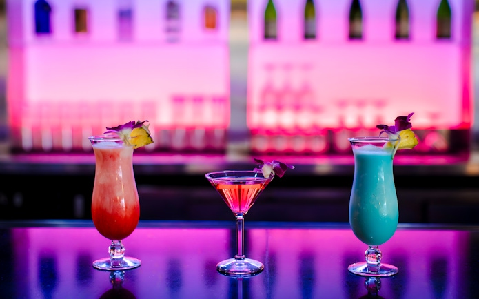 Three cocktails on a table at Rock-a-Hula show, Waikiki, Hawaii.