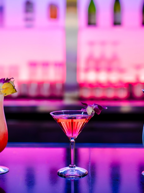 Three cocktails on a table at Rock-a-Hula show, Waikiki, Hawaii.