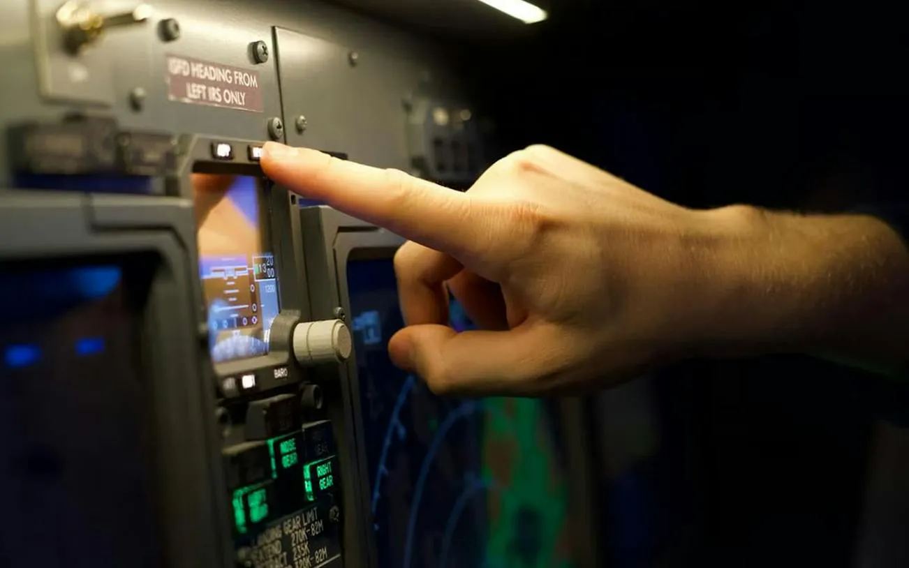 Hand adjusting controls in a Boeing 737 flight simulator, Istanbul.