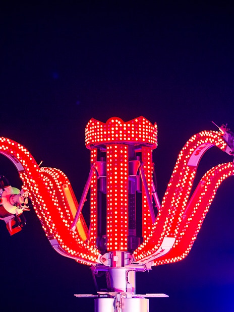 Thrill ride with red lights at Lusail Winter Wonderland.